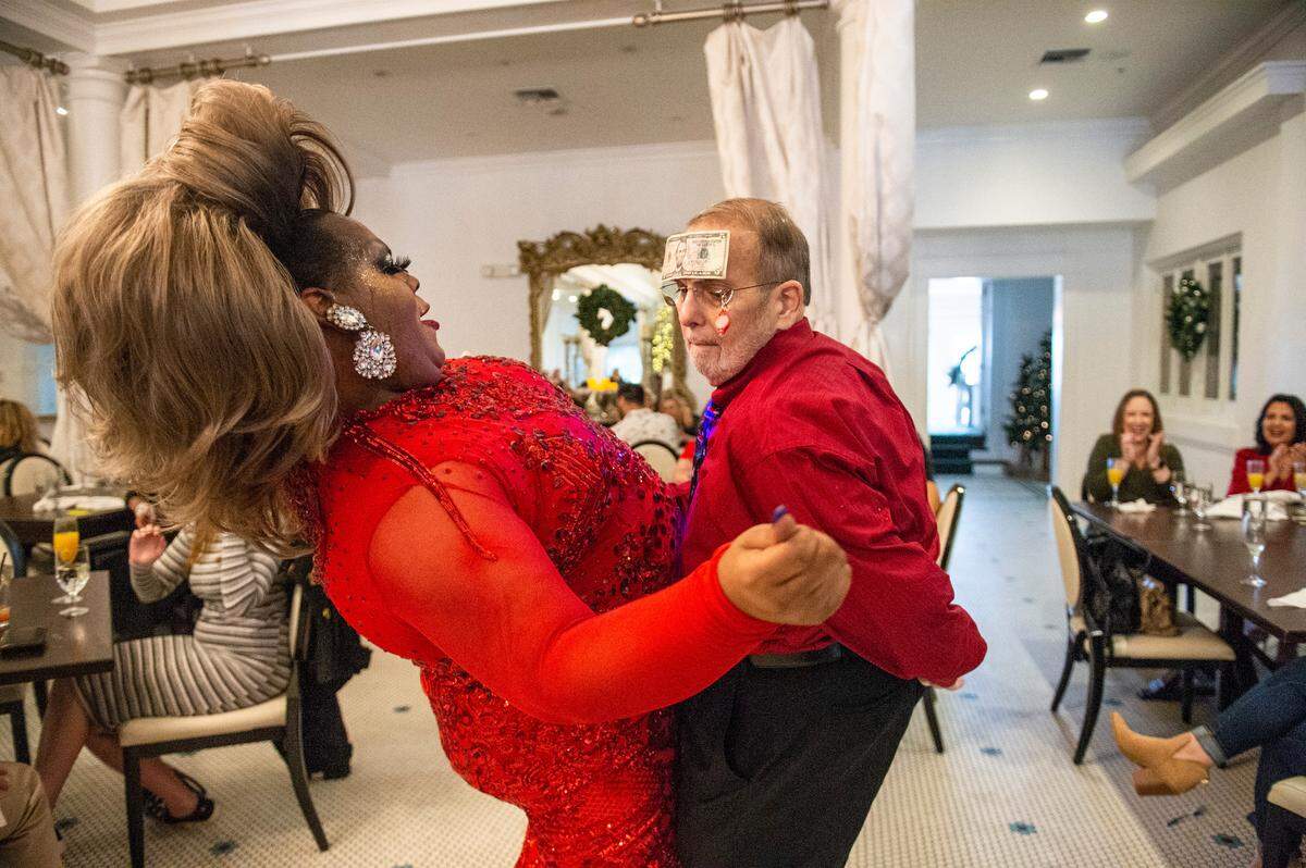 Steve Delahousey, right, a regular at the White Pillars’ drag brunch, dances with drag queen Ladi Phat Kat during drag brunch at White Pillars on Sunday, Dec. 19, 2021.