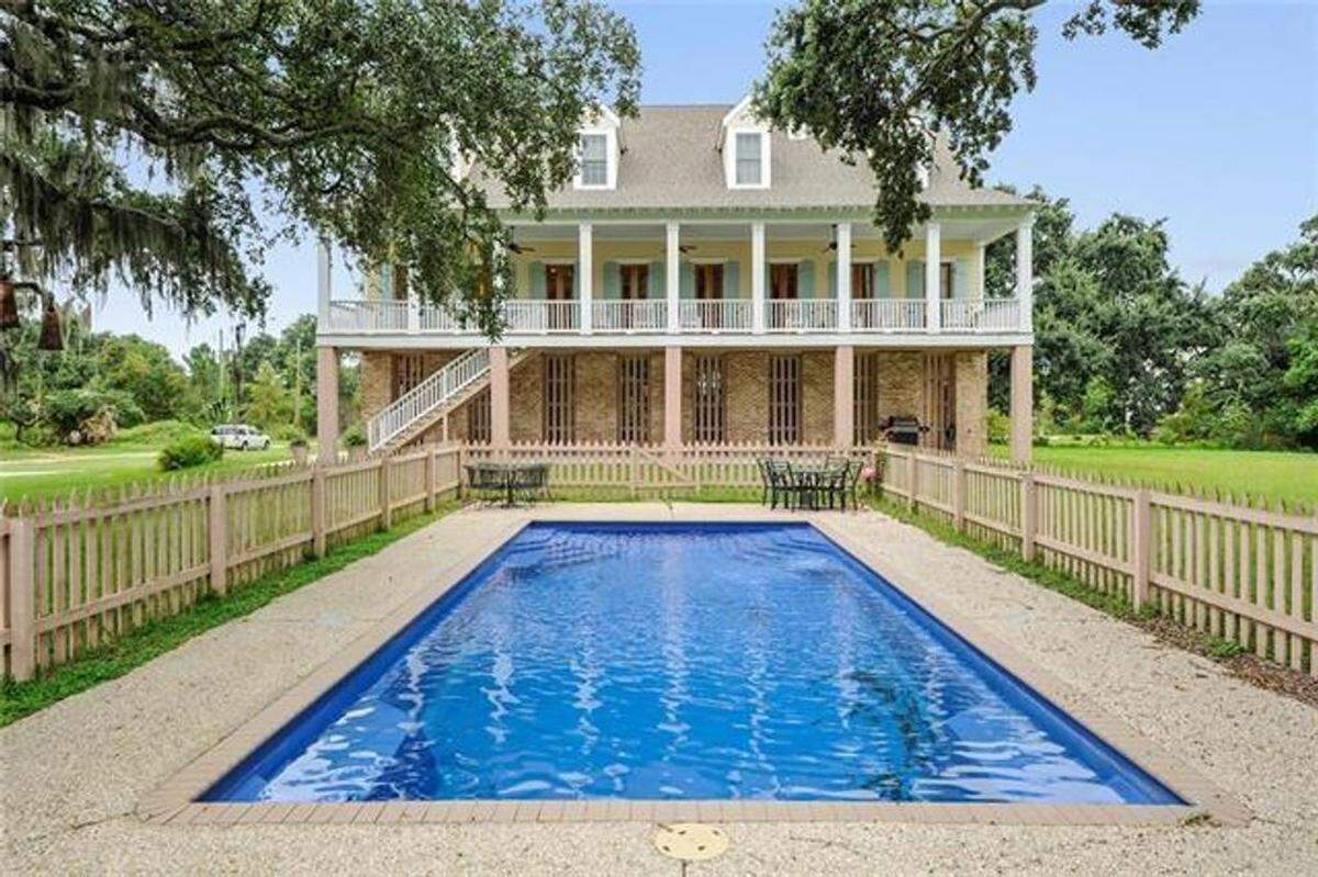 The pool of the estate at 794 W. Beach Boulevard is still and shaded.