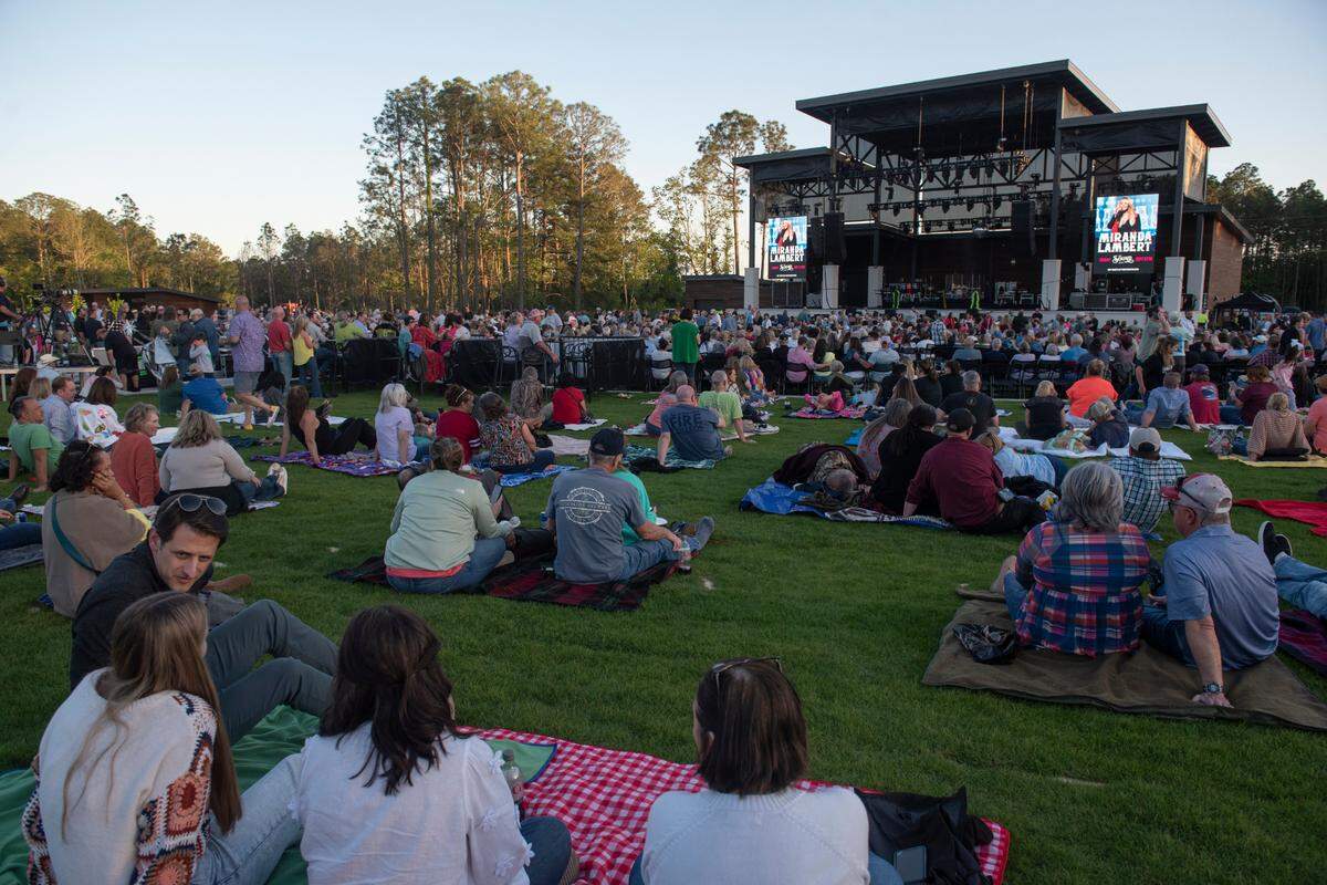 Fans relax on the lawn before the inaugural show at The Sound Amphitheater in Gautier on Friday, April 12, 2024.