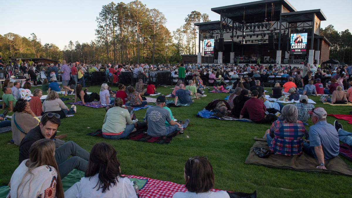 Fans relax on the lawn before the inaugural show at The Sound amphitheater in Gautier on Friday, April 12, 2024. 
