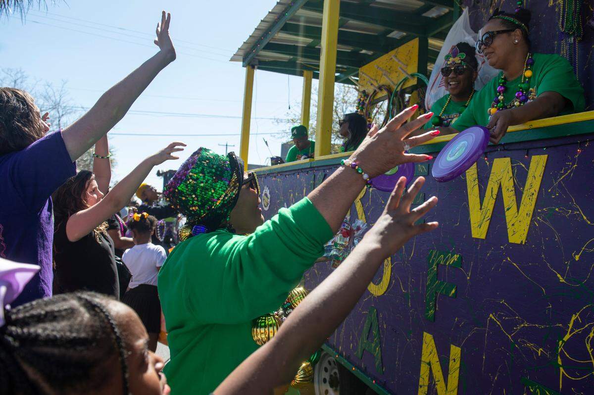 Krewes toss beads and other throws during the Jackson County Carnival Association Mardi Gras parade in Pascagoula on Saturday, March 1, 2025.