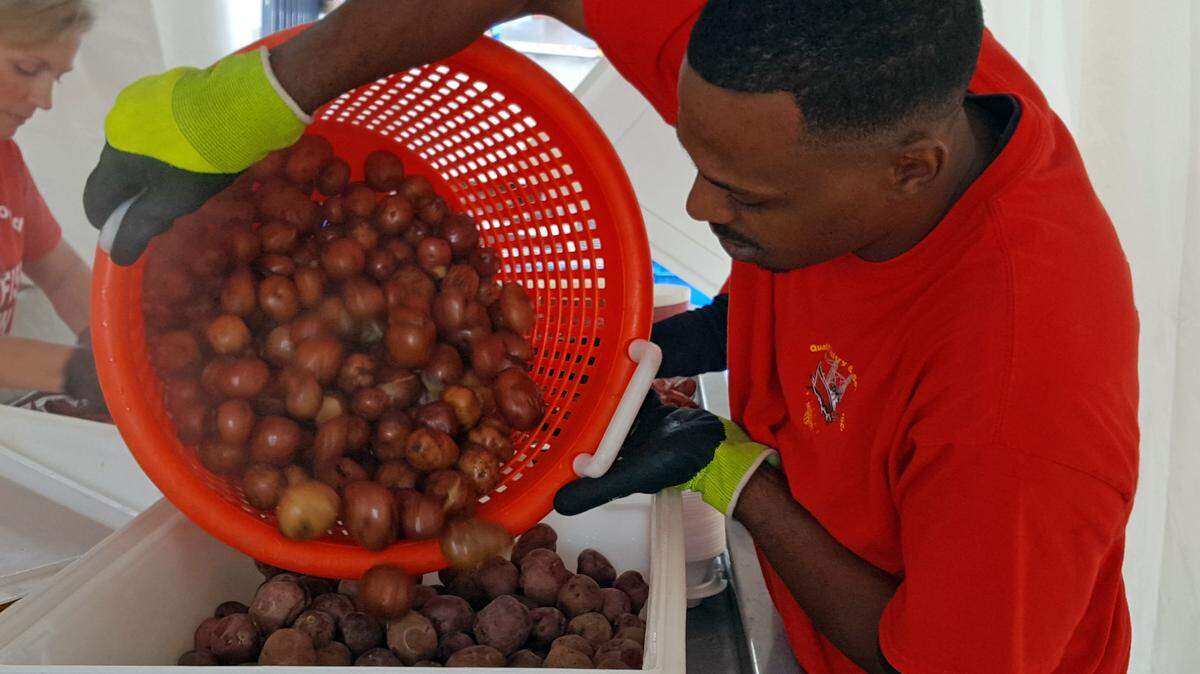SHANNON DAVIDSON/SPECIAL TO THE SUN HERALDPhillip Pritchell (cq) of Biloxi prepares boiled red potatoes for Quality Seafood during the 24th Crawfish Music Festival on Saturday April 16th
