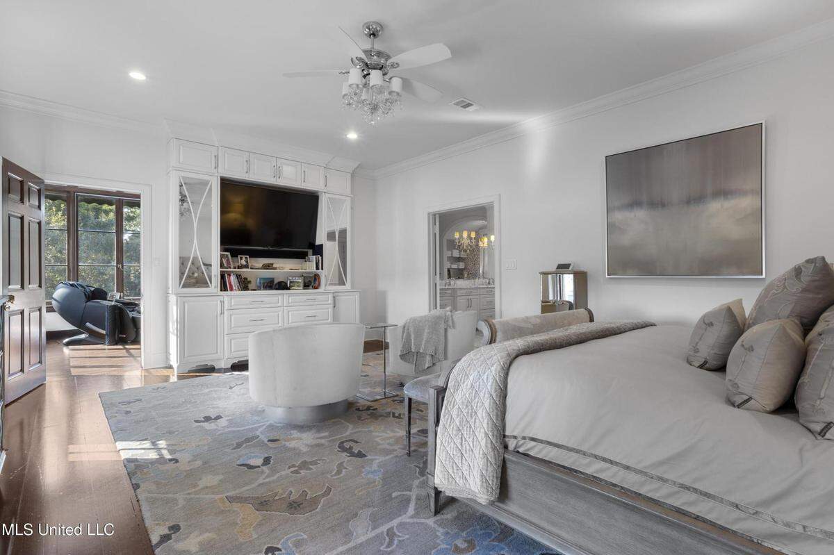 The primary suite in this Gulfport mansion on the market includes an office with floor-to-ceiling windows.