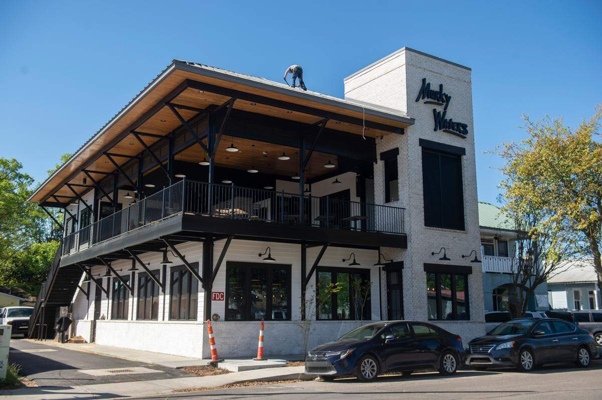 Workers continue to complete construction of the new Murky Waters building in Ocean Springs. The new location will open soon and like the original that opened in 2014, will have a large covered patio and stage in the middle of the action on Government Street.
