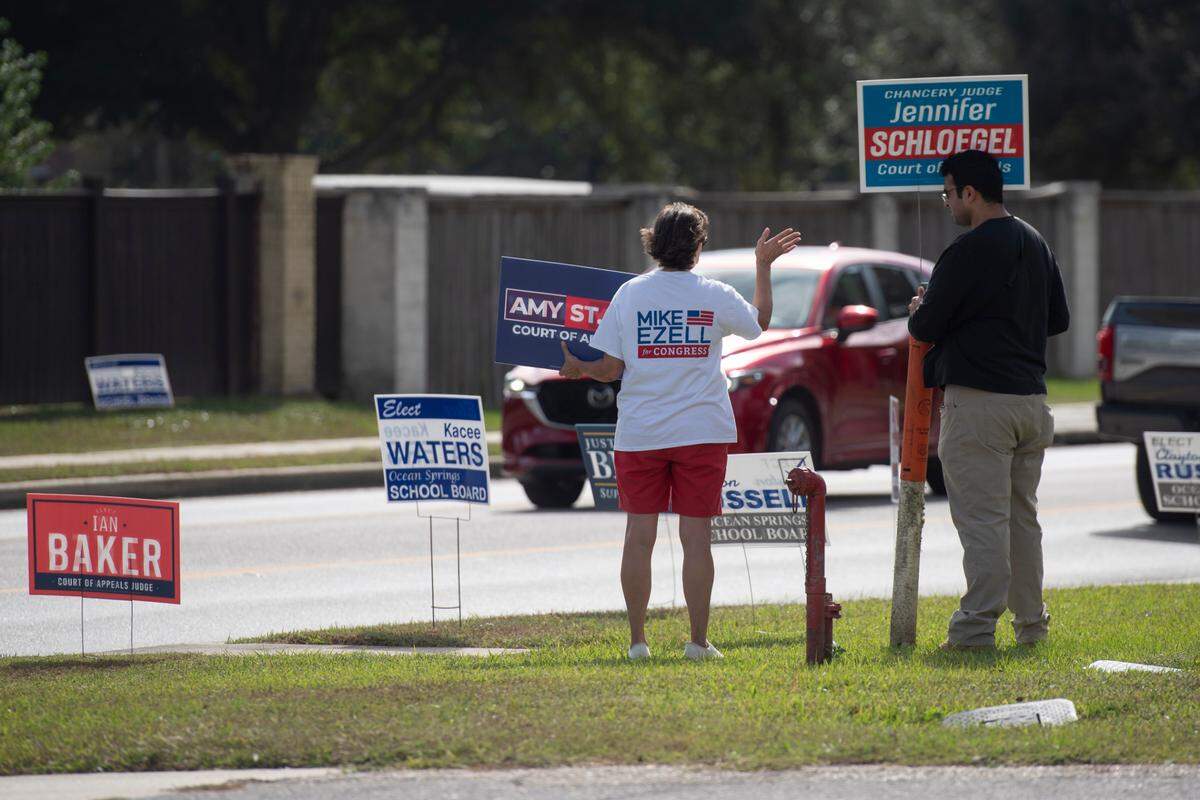 Suzette Ezell (left), the wife of U.S. Rep. Mike Ezell’s greets voters Tuesday, Nov. 5, 2024, along with Eamon Mohiuddin at the Fountainbleau Community Center in Jackson County.