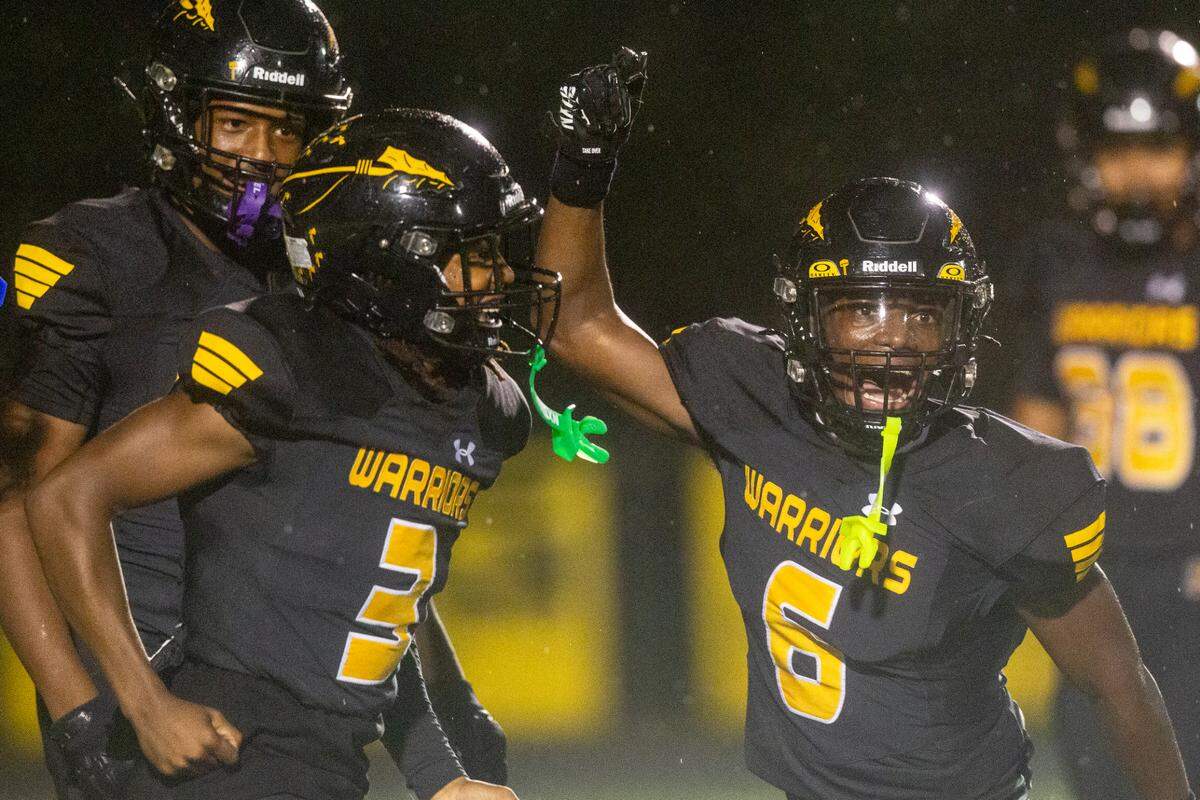D’Iberville’s Jordan Walley and Andre Crosby react after Walley scored a touchdown during a game between D’Iberville and Wayne County at Warrior Stadium in D’Iberville on Friday, Oct. 4, 2024.