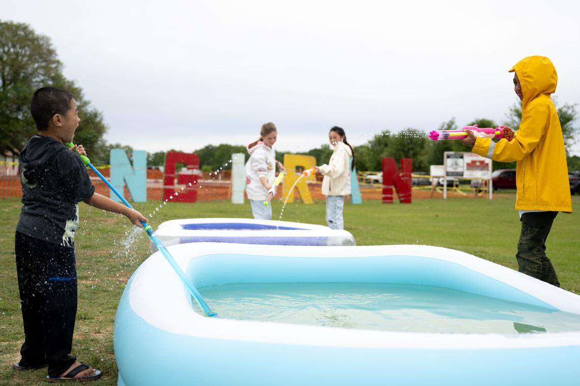 Children play with water guns during Songkran at the Wat Buddhametta Mahabaramee in Gautier on Sunday, April 19, 2026.