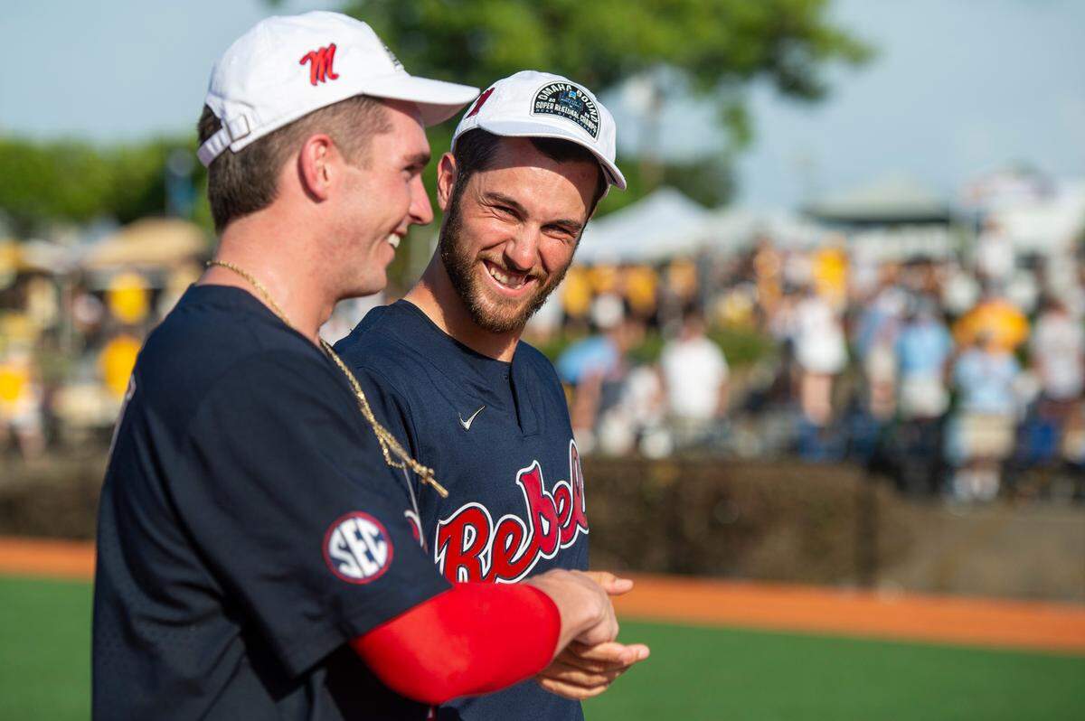 Ole Miss players hug after winning a shot at the College World Series during the Super Regionals Final at Pete Taylor Park in Hattiesburg on Sunday, June 12, 2022.