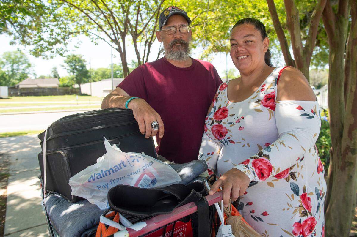 Patricia Davis, right, and her fiancé David Hartman pose for a portrait outside the Back Bay Mission in Biloxi on Friday, April 11, 2025. Davis and Hartman, who have been homeless for 3 years, say they finally found a safe spot to sleep where they say police won’t bother them and they won’t bother neighbors while they wait for a housing voucher.