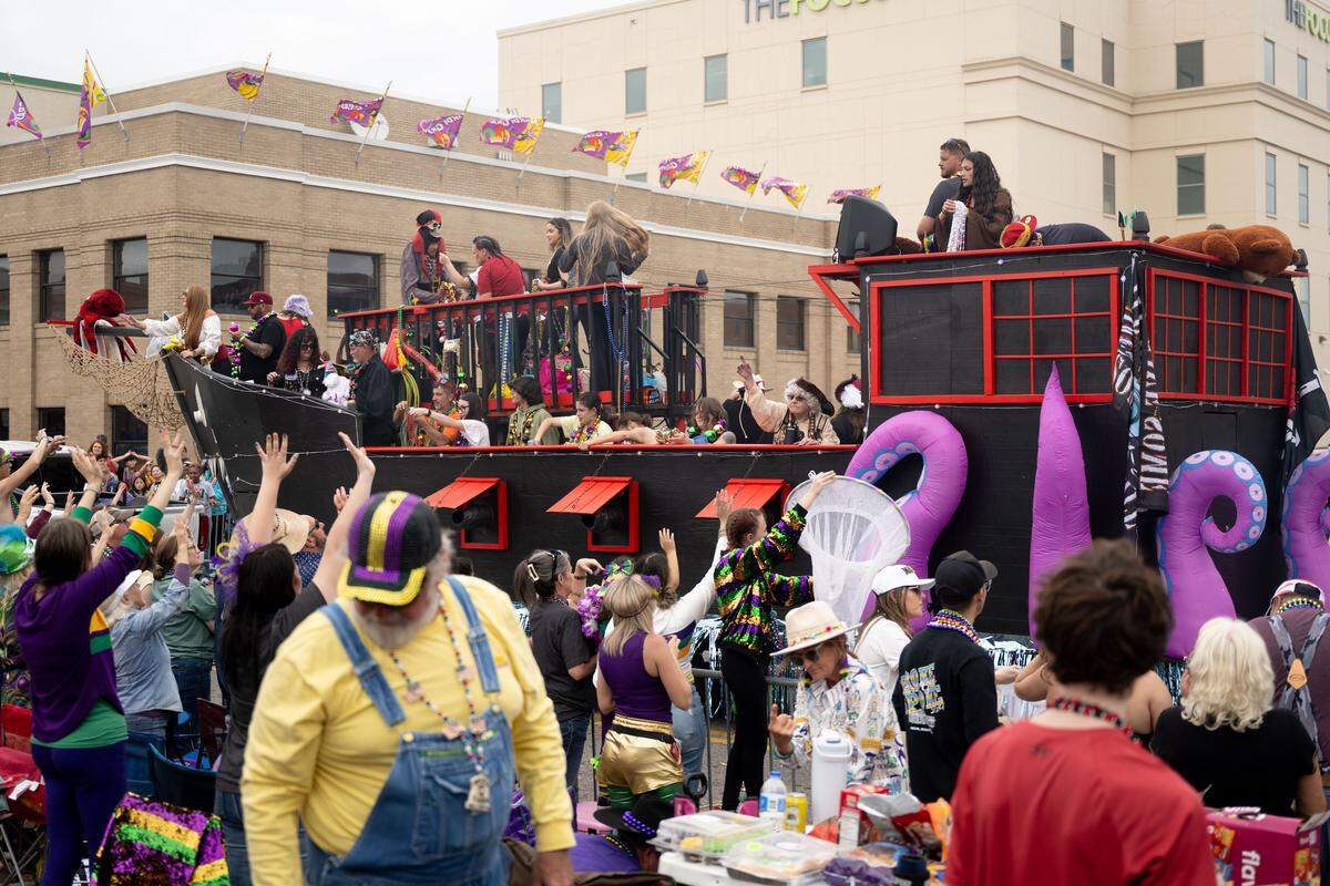 A Mardi Gras float in the form of a pirate ship drives down Lameuse Street.