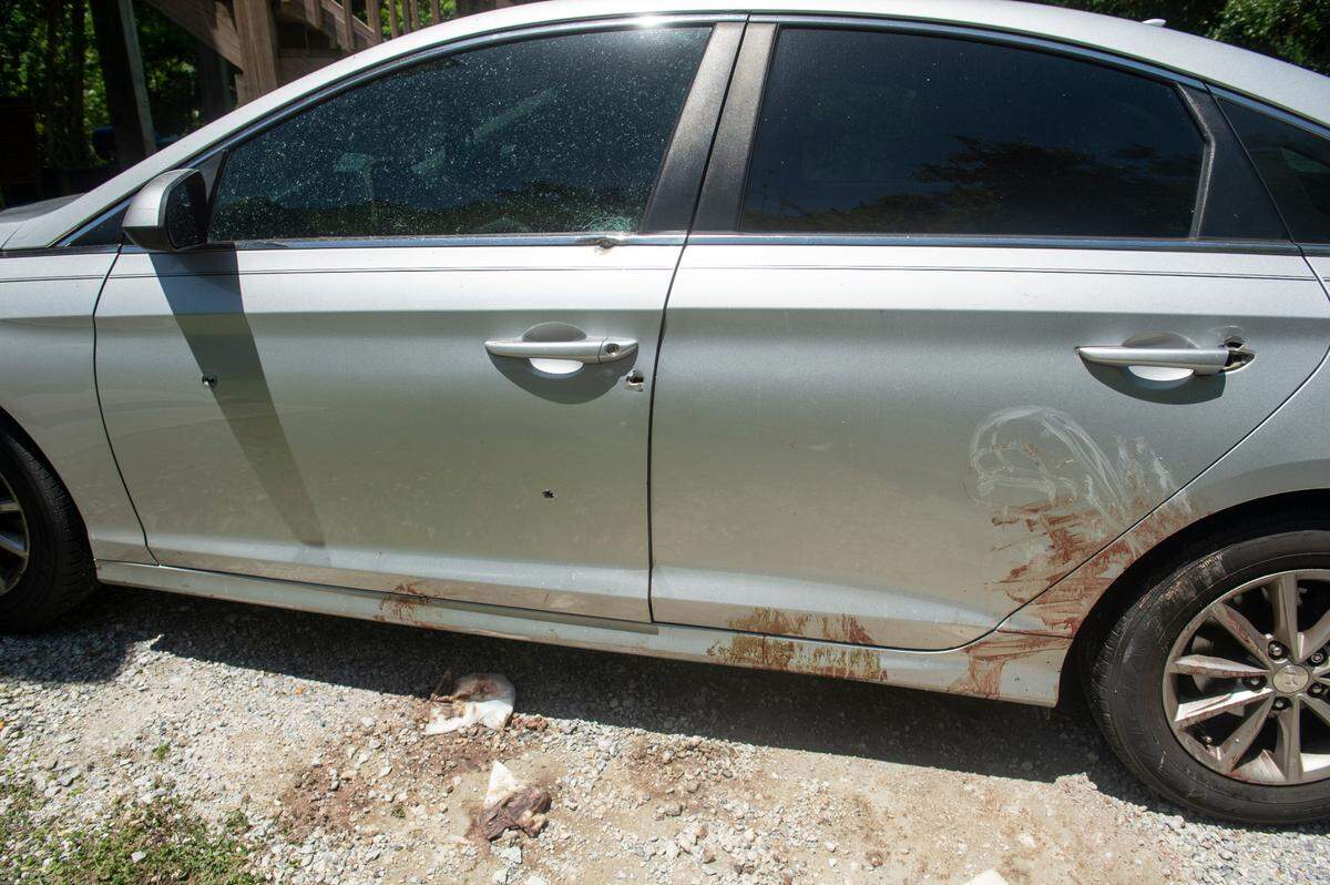 A car riddled with six bullet holes sits on the property where a shooting occurred early on Sunday, April 30, 2023 in Bay St. Louis killing two teenagers and injuring four others.
