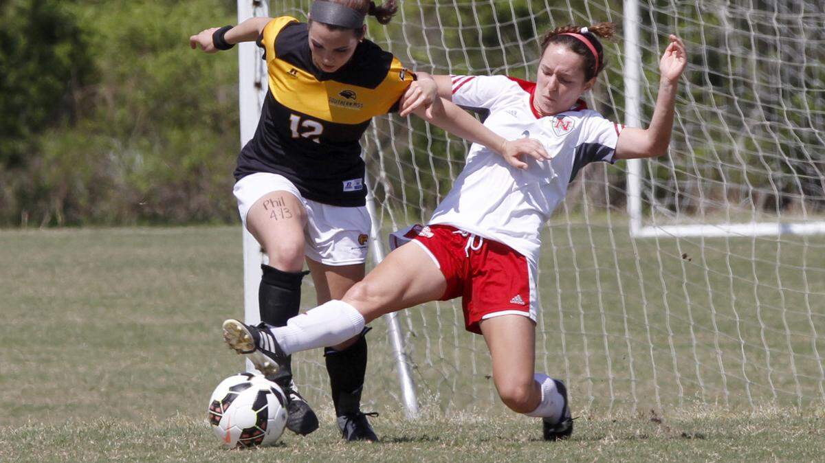 TIM ISBELL/SUN HERALD 
 Beth Coleman of Southern Miss has the ball knocked from her by Nicholls State's Hannah Savoie, Saturday, Apr. 9, 2016.