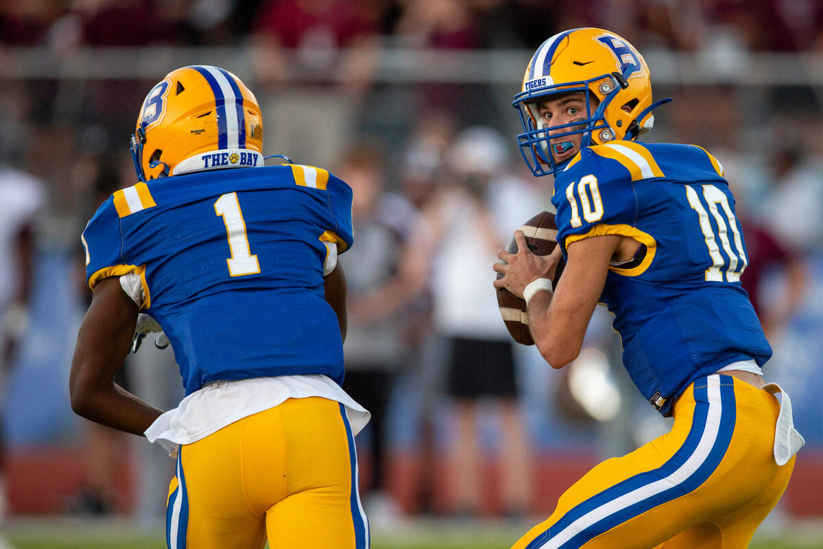 Bay High’s Xander Ladner fakes a pass off to Jaylen Antoine before looking for a pass during a game between Bay High and Long Beach at Tiger Stadium in Bay St. Louis on Friday, Sept. 13, 2024.