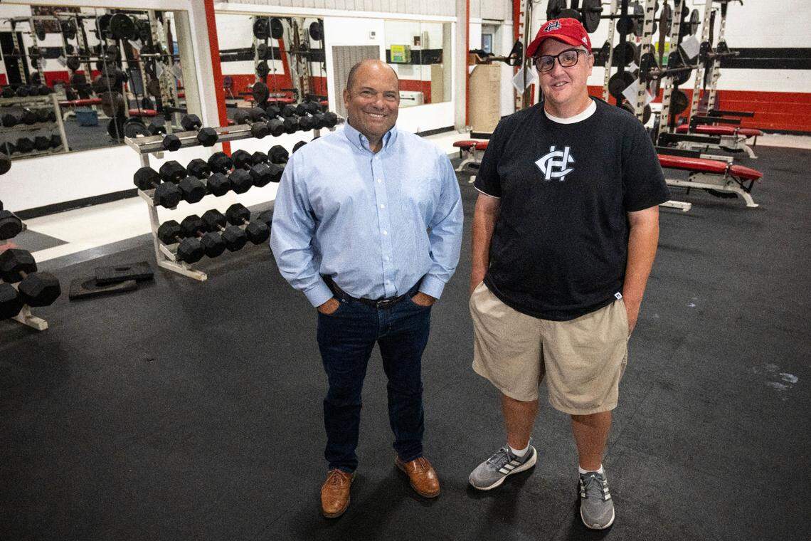 Brenan Compretta, left, and Jeremy Turcotte, former Bay High football coaches, pose for a portrait at Harrison Central High School, where Turcotte now coaches, on Tuesday, June 10, 2025.