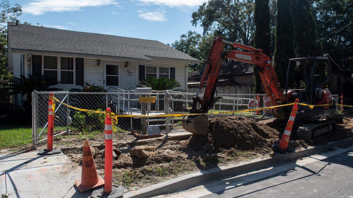 Construction equipment sits outside John Higgins’ home in Biloxi on Friday, Oct. 1, 2021. The sidewalk and driveway is being replaced after being improperly installed by Oscar Renda at a grade that was so steep it caused Higgins to fall.