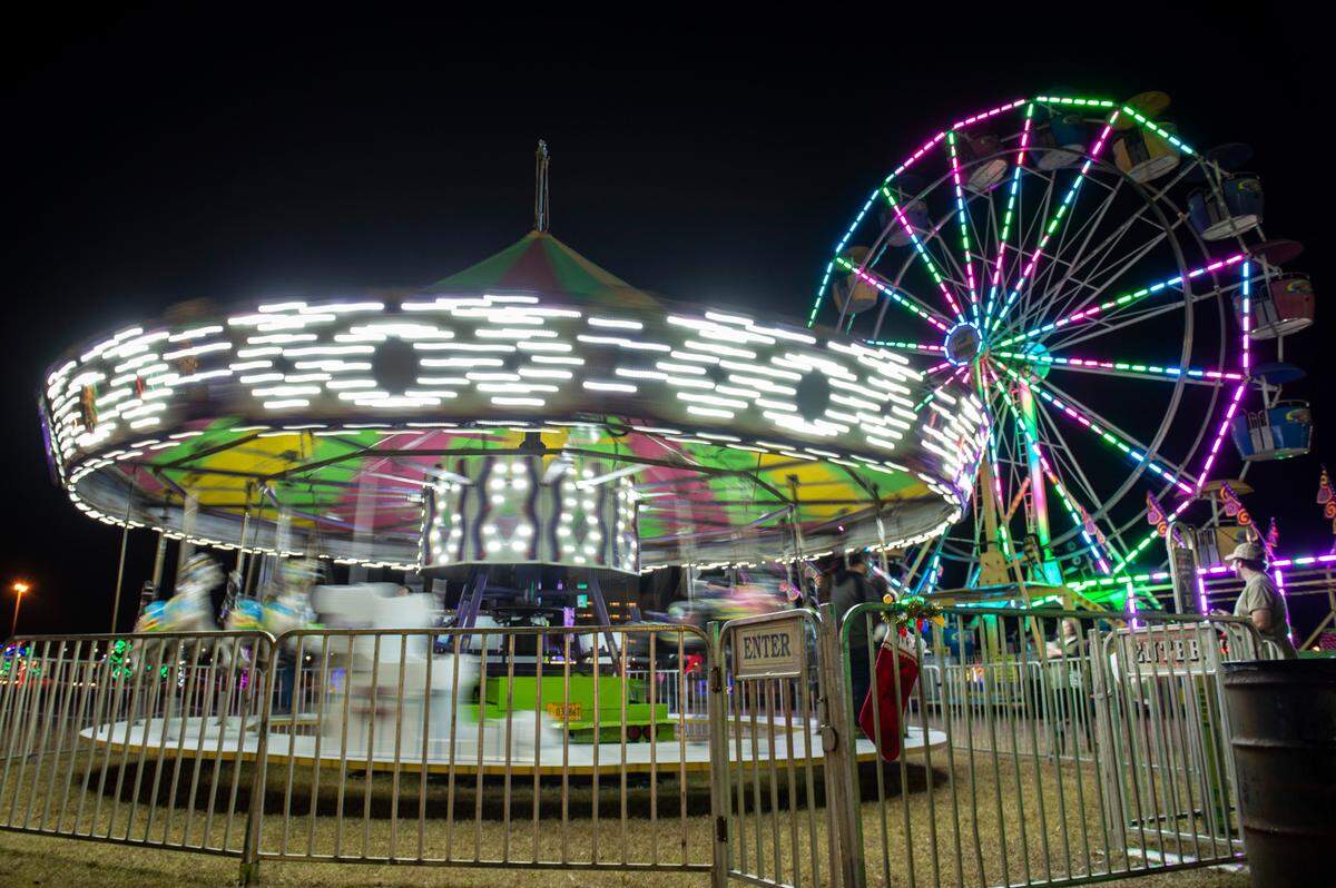 The merry-go-round and Ferris wheel during the Harbor Lights Winter Festival at Jones Park in Gulfport on Thursday, Dec. 2, 2021.