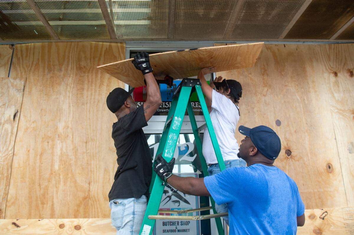 Maintenance workers for Keith’s Superstores put up plywood on the Pass Christian location in preparation for Hurricane Francine on Tuesday. Most schools and some businesses are closing Wednesday.