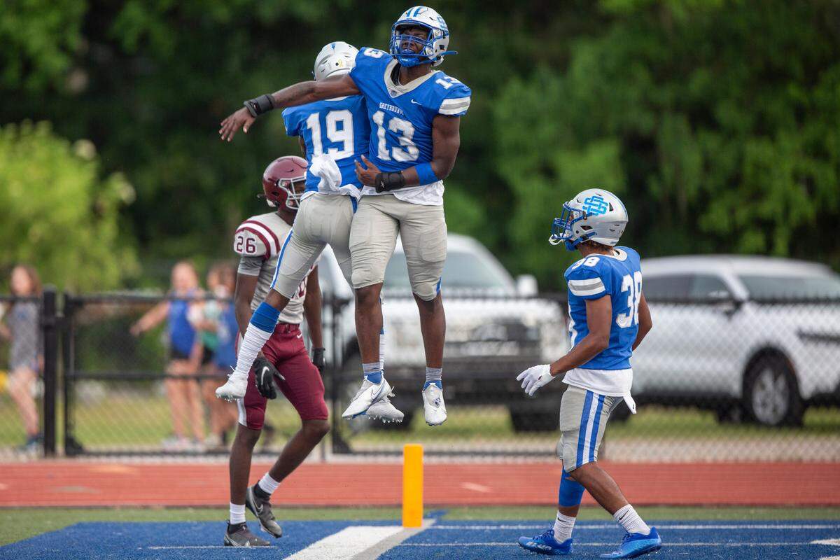 Ocean Springs’ Khris Bonds and Keshawn Thomas celebrate after scoring a touchdown during a Spring Game against Picayune at Greyhound Stadium in Ocean Springs on Friday, May 13, 2022.