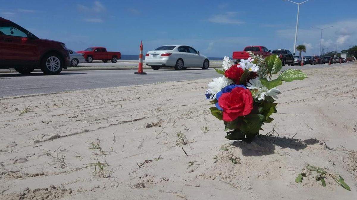 A bouquet sits near the spot on U.S. Highway 90 where Tyler Cooke, 16, was killed in a two-vehicle car crash in 2017.