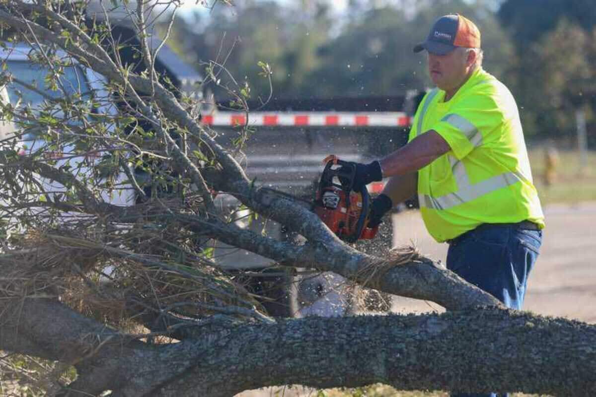 Crews clear away fallen trees and other storm debris in Biloxi on Oct. 29, 2020 after Hurricane Zeta tore into the Mississippi Coast. Trees blocked roads throughout the three Coast counties and several old live oak trees snapped or were uprooted in the high winds.