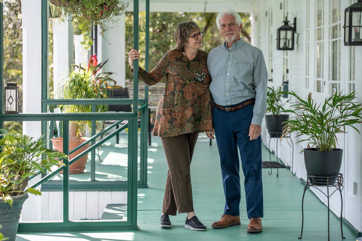 Current owners Ellis Anderson, left, and husband Larry Jaubert stand on the veranda of the former Webb School, which Anderson renovated as her home before they married. Anderson, a writer and publisher, and Jaubert, an architect, have worked to preserve the historic building, which is now for sale. They offered a tour on Wednesday, Nov. 3, 2021.