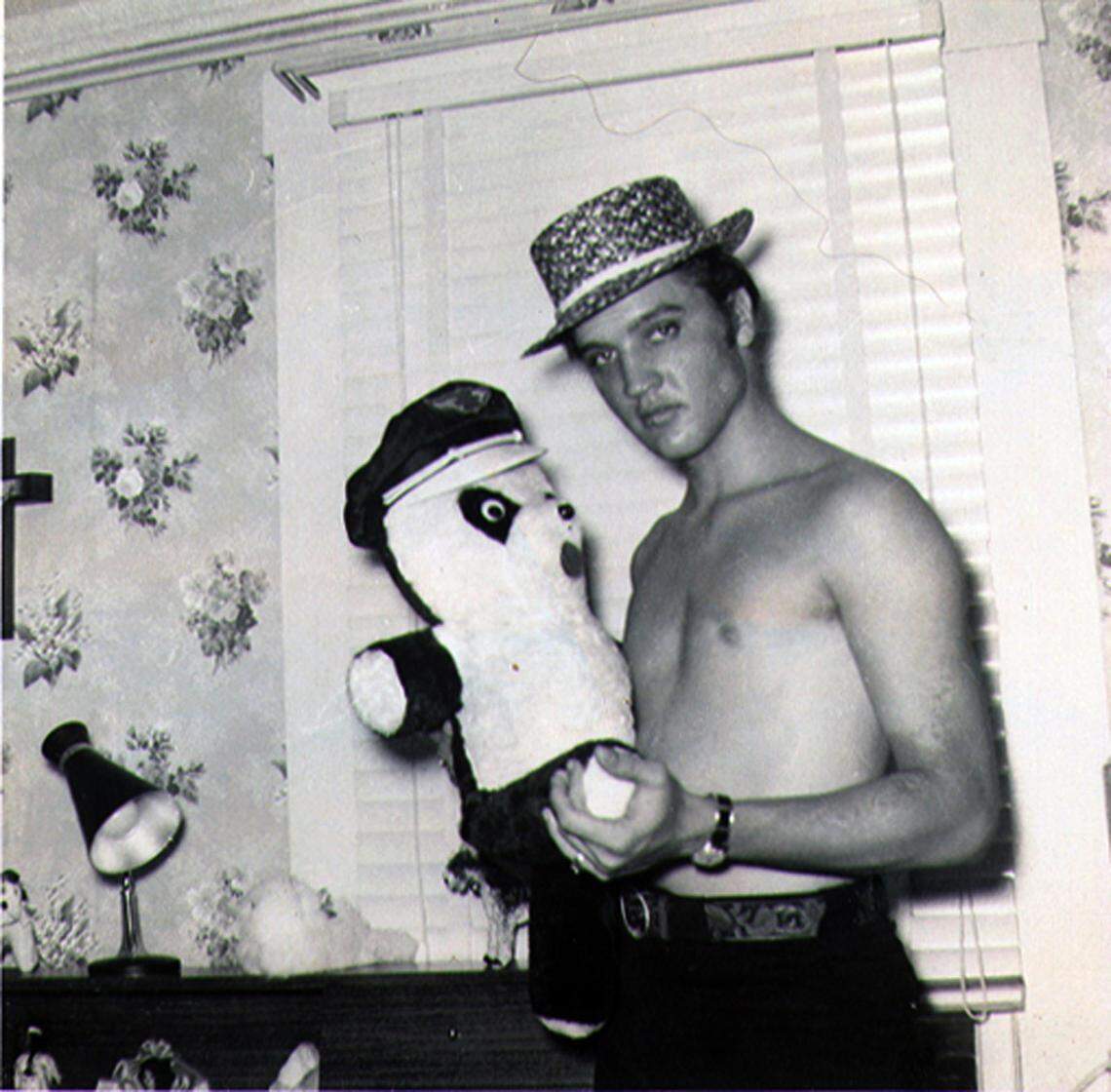 Elvis Presley holds a teddy bear at June Juanico’s home in Biloxi in 1956.