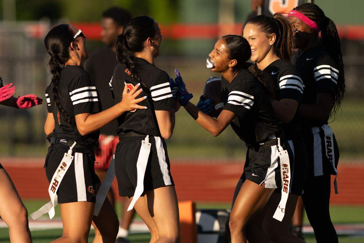 George County players celebrate a touchdown scored by Kourtney Papania (8) during a flag football playoff game at Biloxi High School on Monday, May 4, 2026.