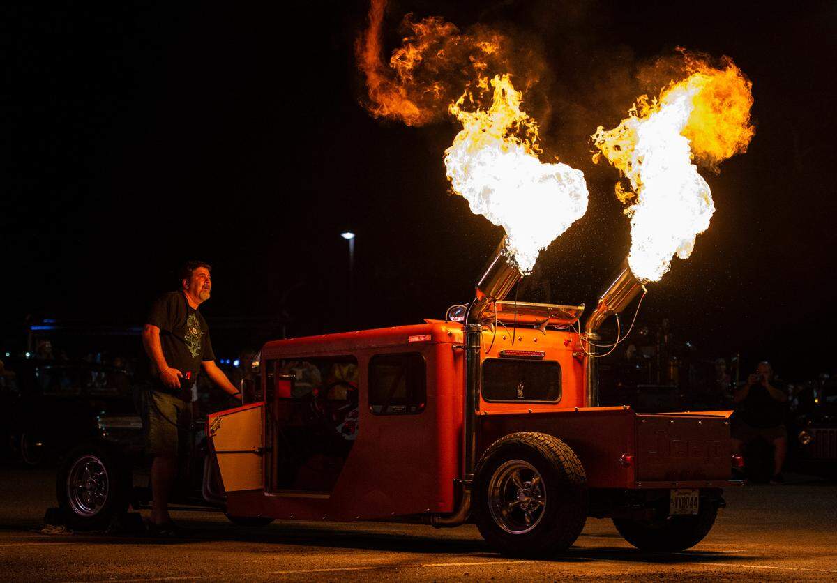 Harlyn Mallett watches flames shoot out of his 1979 Jeep Postal during a flame throwing competition, where drivers compete to see which car can produce the biggest flames, at Island View Casino in Gulfport during Cruisin’ The Coast on Tuesday, Oct. 5, 2021.