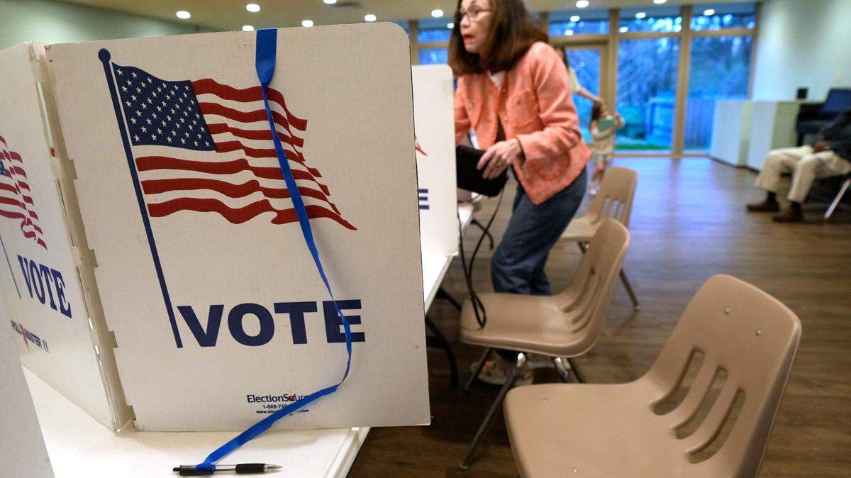 A lone voter has a choice of privacy voting kiosks at which to cast her ballot Tuesday during Mississippi’s party primaries. Mississippians are voting in party primaries for all four of the state’s U.S. House seats and one U.S. Senate seat.