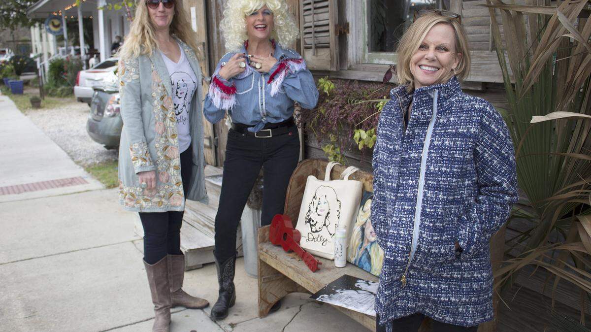 JEFF CLARK/SUN HERALDAnn Madden, left, and Sandy Maggio, right, owners of Smith and Lens, discuss Saturday's 'Dolly Should' with 'Dolly' (Michelle Allee).