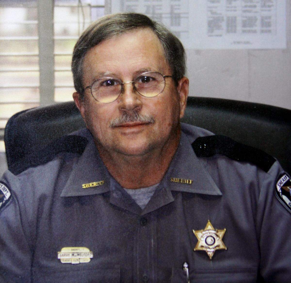 George County Sheriff Garry Welford died on July 21 after he was struck by a truck while trying to put out spikes to stop the fleeing vehicle.