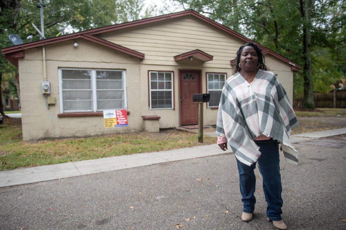 Esther Faye Payton, a plaintiff in a federal lawsuit against the city of Ocean Springs, poses for a photo outside her family’s home on Cash Alley in Ocean Springs on Thursday, Oct. 12, 2023. Payton’s grandparents built the home brick by brick, purchasing each brick over time.