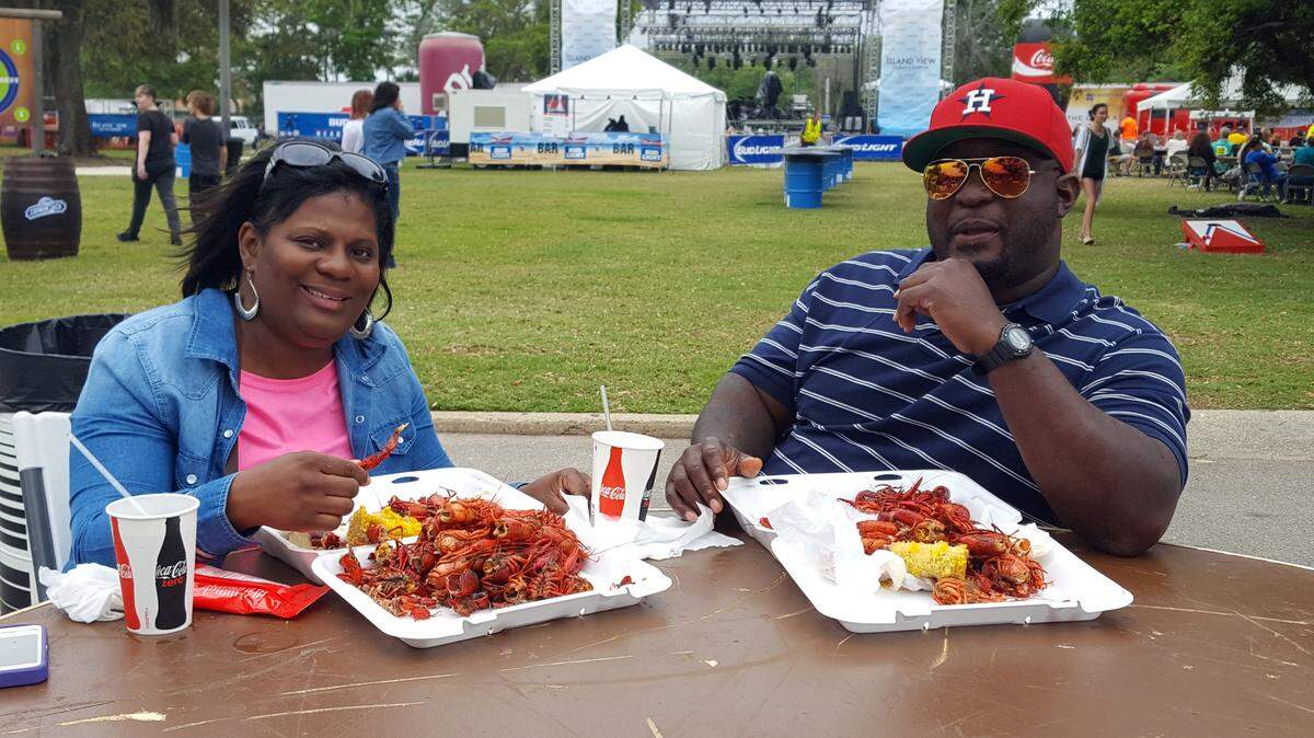 SHANNON DAVIDSON/SPECIAL TO THE SUN HERALDShantel and Derwin Phlegm enjoy their plate of crawfish on the grounds of the Coast Coliseum for the 24th annual Crawfish Music Festival on Saturday in Biloxi.