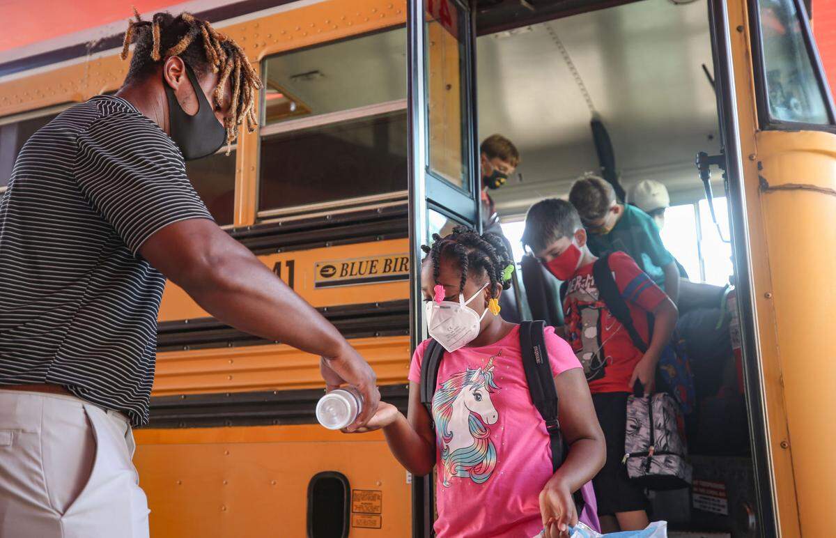 Hand sanitizer was given to each North Bay Elementary student as they loaded off the bus at the front of the school August 5, 2020.