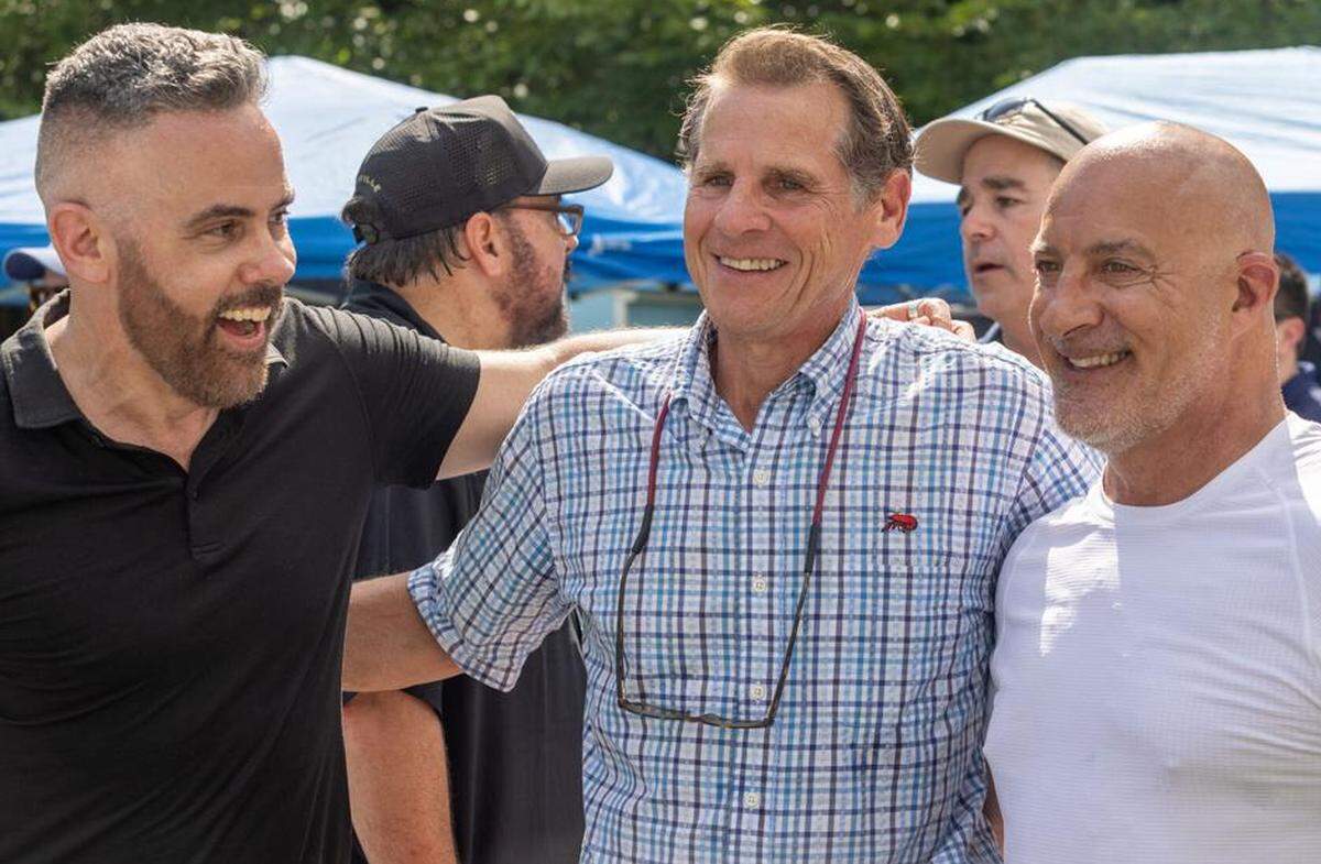 Josh Morgerman, left, Pass Christian Mayor Jimmy Rafferty (center), and Jim Cantore, right, pose for a photo in Bay St. Louis on June 7, 2024.