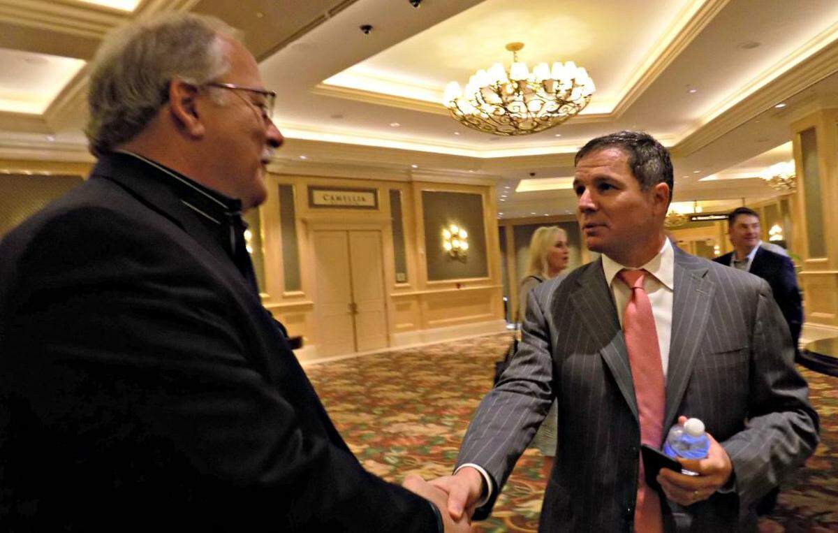 Geoff Freeman, right, former president of the American Gaming Association, shakes hands with John Ferrucci during the American Gaming Association at the Beau Rivage Resort and Casino in this Sun Herald file photo.