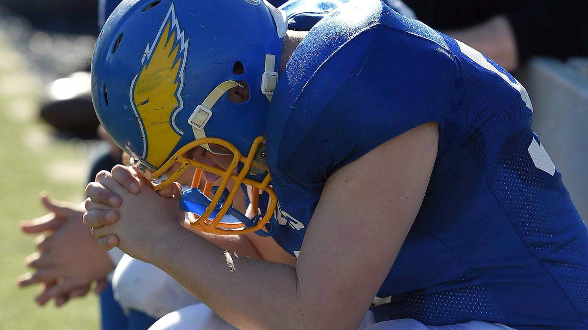 CHRIS TODD/SPECIAL TO THE SUN HERALD 
 Resurrection Catholic's David Alfred prays on the bench late in the fourth quarter on Friday, December 4, 2015, at the MHSAA State Football Championships in Vaught-Hemmingway Stadum on the Ole Miss Campus in Oxford, Miss.