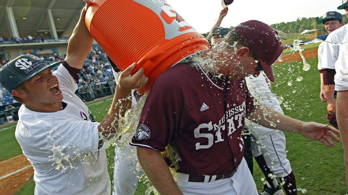 Mississippi State manager John Cohen is dunked by his team following their 3-0 win over Vanderbilt in an NCAA college baseball game during the Southeastern Conference tournament championship in Hoover, Ala., Sunday, May 27, 2012. (AP Photo/Dave Martin)