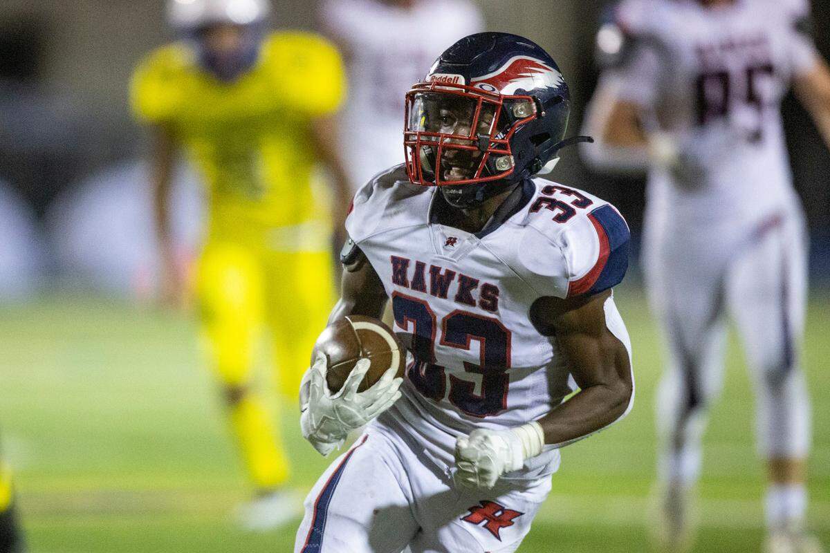 Hancock’s Destin Coleman carries the ball down the field during a game against St. Martin at Joe Barlow Stadium in St. Martin on Friday, Sept. 30, 2022.