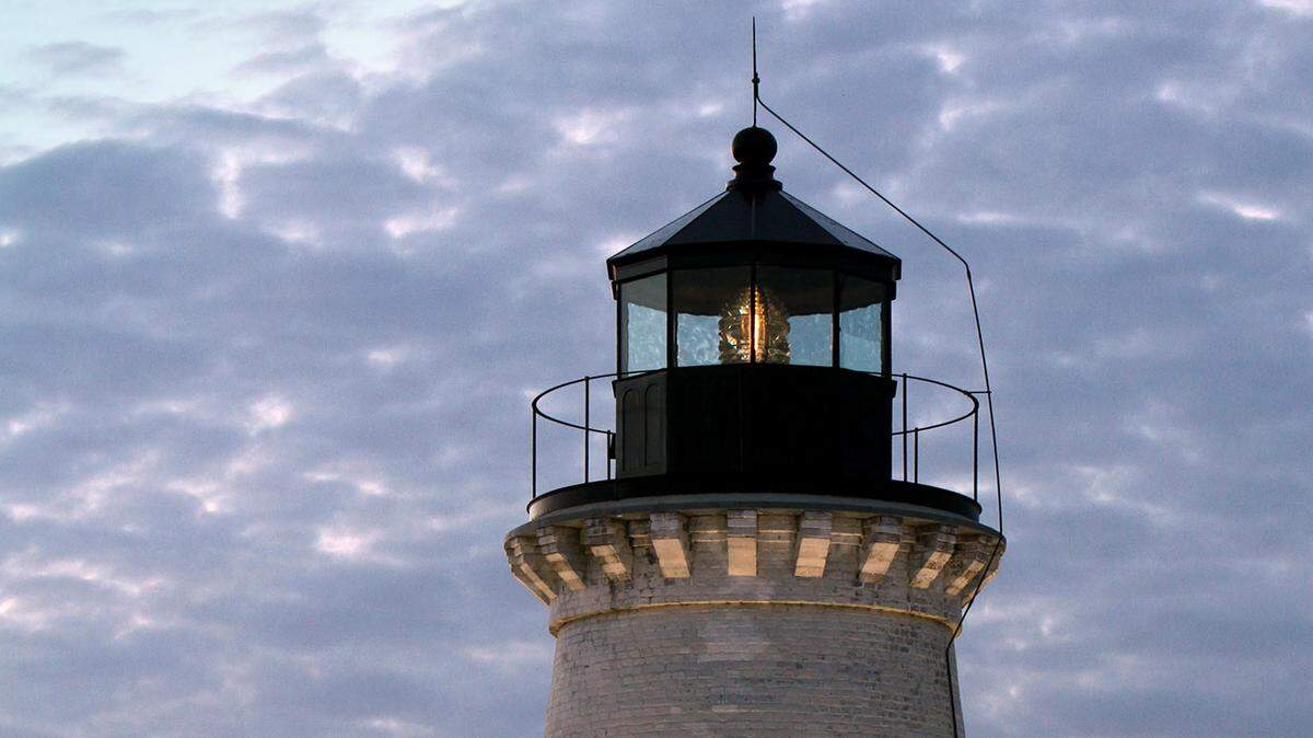 TIM ISBELL/SUN HERALDA setting sun turns the clouds different colors behind the Round Island Lighthouse in Pascagoula, Friday, Nov. 13, 2015.