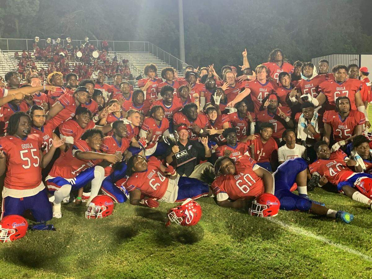 The Pascagoula Panthers pose with the Battle of the Cats trophy after defeating Moss Point 31-0 in Moss Point on August 25, 2023.
