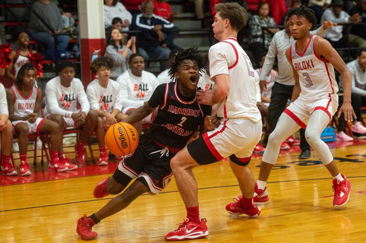 Harrison Central’s Aujaylen Barron dribbles the ball past Biloxi’s Beau Miles during the district title game at Harrison Central High School in Gulfport on Friday, Feb. 10, 2023.