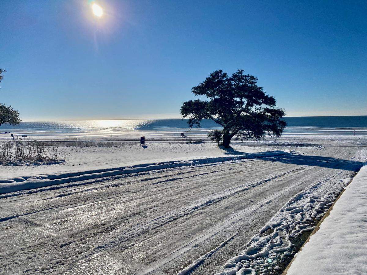 Menge Avenue at U.S. 90 on Wednesday morning in Pass Christian shows why residents are being urged to stay off roadways. Snow and ice from Tuesday’s storm remain on roads after a night and morning of below-freezing temperatures. Temperatures in the 40s are expected to bring relief Thursday.
