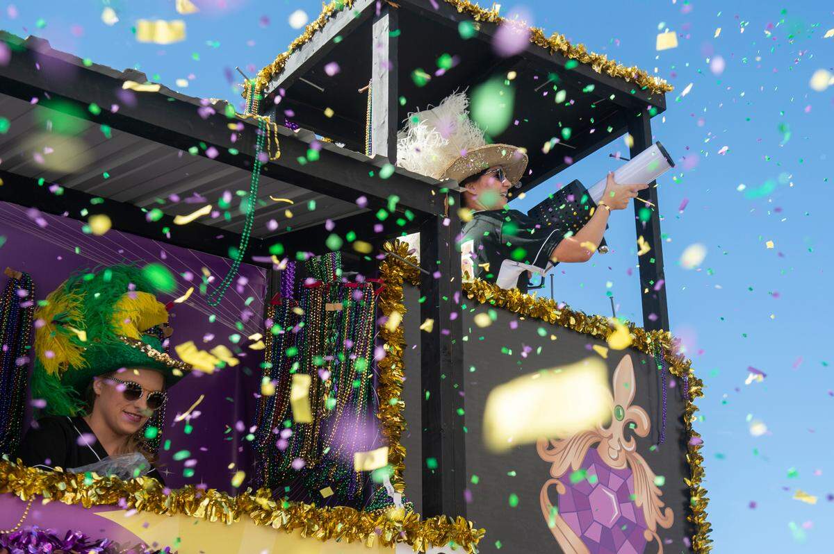 Float riders shoot out confetti during the Gulf Coast Carnival Association’s Mardi Gras parade in Biloxi on Tuesday, Feb. 13, 2024.