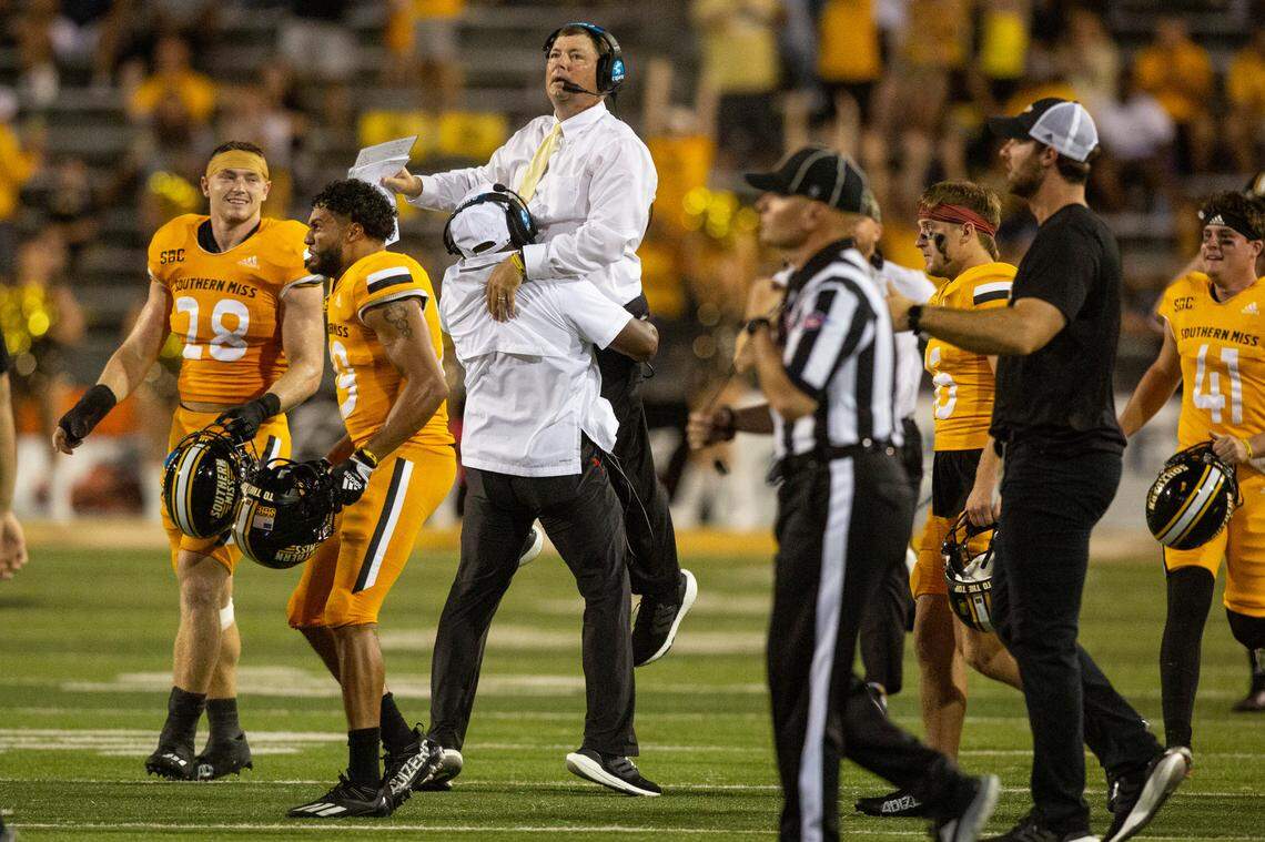 Southern Miss Coach Will Hall gets lifted in the air during a game against Liberty in Hattiesburg, Miss., Saturday, Sept. 3, 2022. Southern Mississippi lost 29-27