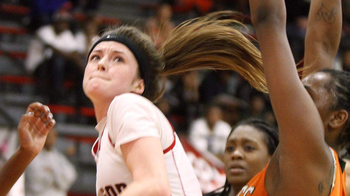 TIM ISBELL/SUN HERALD 
 Harrison Central's Adyn Strickland takes the ball to the hoop as Ameshya Williams of West Harrison defends, Tuesday, Feb. 2, 2016.