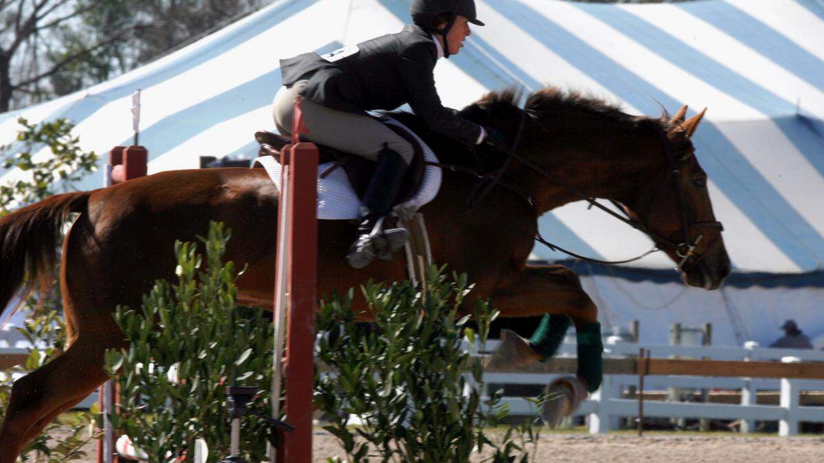 TIM ISBELL/THE SUN HERALD 
 Hailey Henderson rides Huizues through the obstacles at the Gulf Coast Classic.