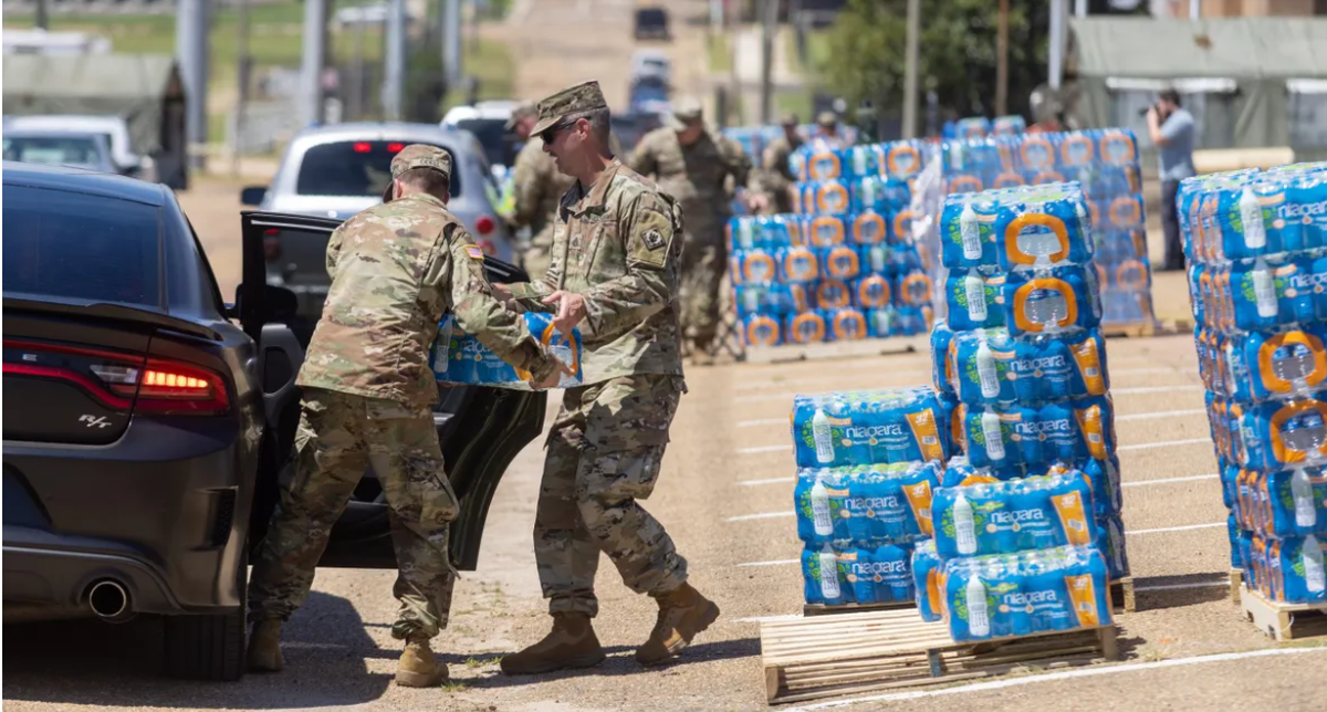 Members of the Mississippi National Guard distribute bottled water to Jackson residents at the Mississippi Trade Mart in 2022. 