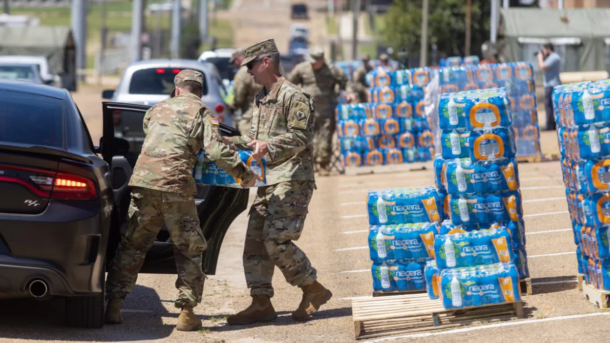 Members of the Mississippi National Guard distribute bottled water to Jackson residents at the Mississippi Trade Mart in Jackson, Miss., Thursday, September 1, 2022. (Credit: Eric Shelton/Mississippi Today)
