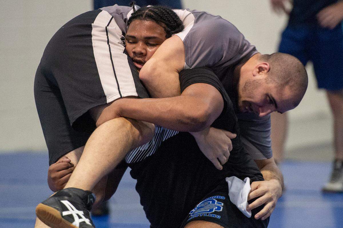 Xavier Smith and assistant coach Nick Bruce practice together during Ocean Springs’ high school wrestling practice at E.H. Keys Alternative Education Center on Thursday, Feb. 8, 2024.